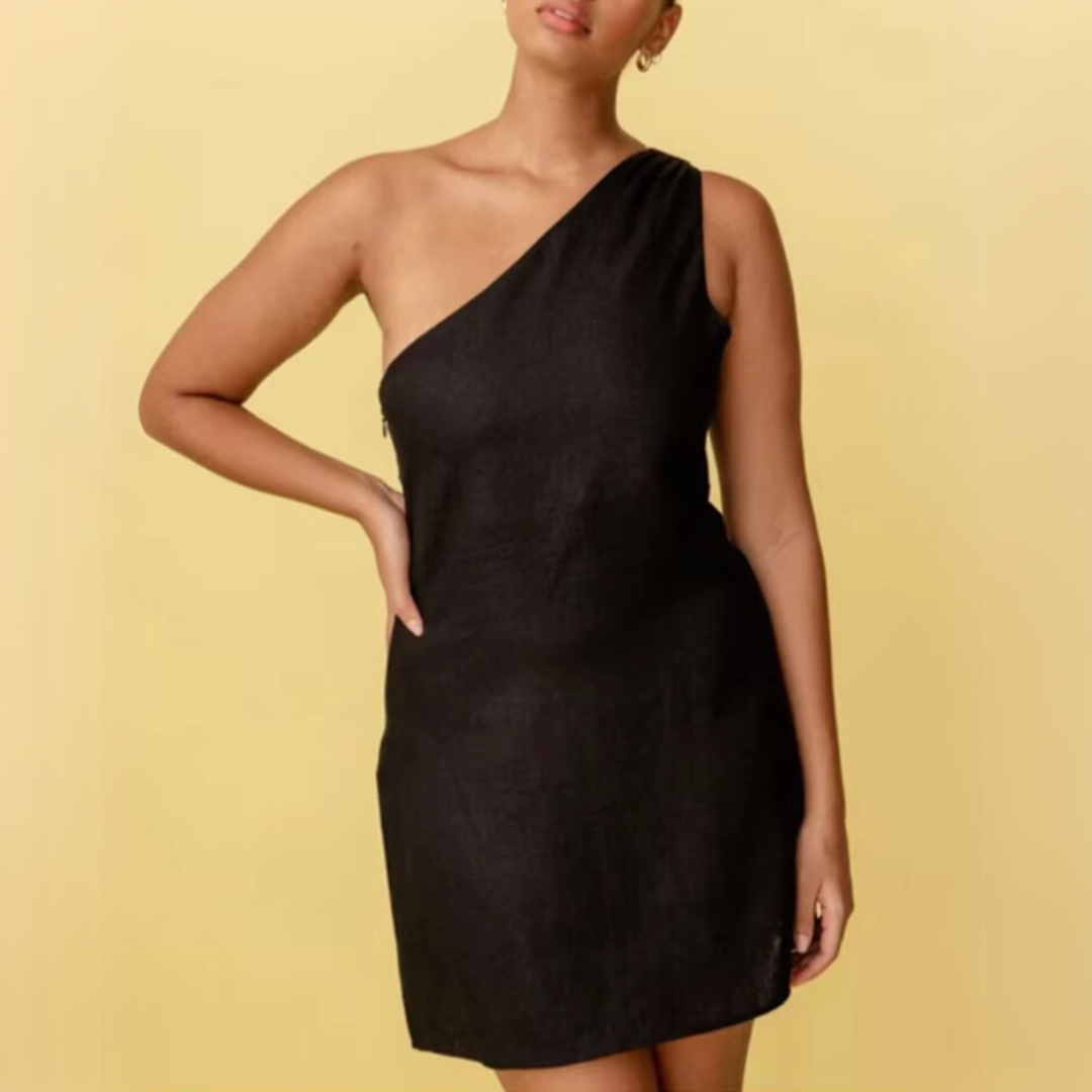 Frau in schwarzem, schulterfreiem Kleid vor gelbem Hintergrund. Elegantes, asymmetrisches Design, Mode, Abendkleid, Damenbekleidung.
