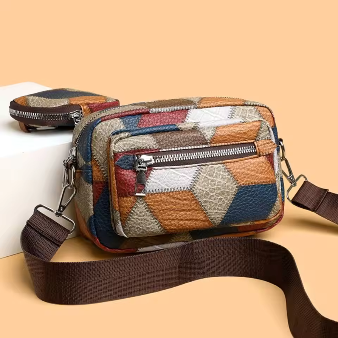 Bunte Umhängetasche mit geometrischem Muster, zwei Reißverschlussfächern und verstellbarem Schultergurt, ideal für Damenmode und Accessoires.