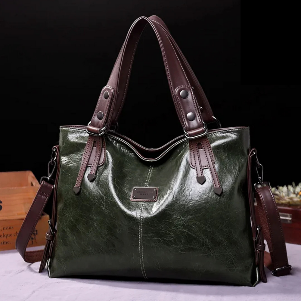 Dunkelgrüne Ledertasche mit braunen Henkeln, elegantes Design, hochwertige Verarbeitung, ideal für Damenmode, stilvolles Accessoire.