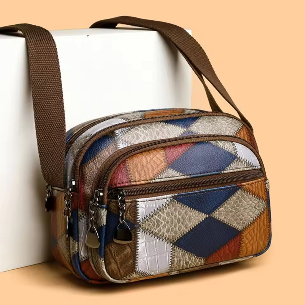 Bunte Patchwork-Umhängetasche aus Leder mit mehreren Reißverschlussfächern, braunem Schultergurt, ideal für Damenmode und Accessoires.
