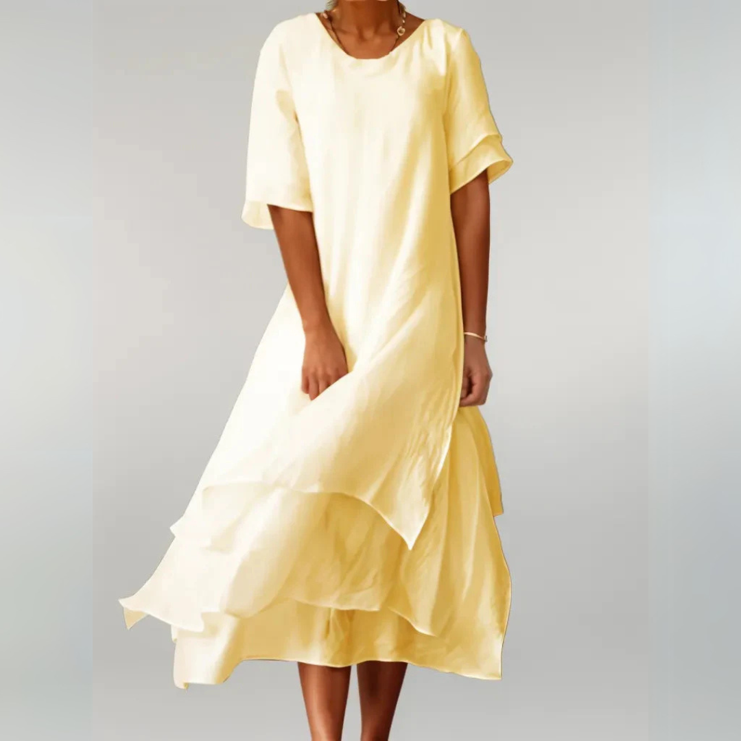 Gelbes Sommerkleid aus leichtem Stoff, knielang, mit kurzen Ärmeln. Perfekt für Damenmode, Sommeroutfits und elegante Freizeitkleidung.