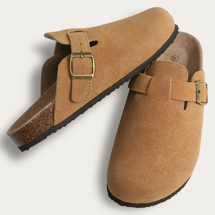 Braune Wildleder-Clogs mit goldener Schnalle, ergonomischem Fußbett und rutschfester Sohle. Bequeme, stilvolle Schuhe für Alltag und Freizeit.