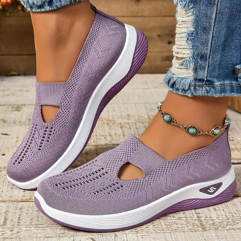 Lila Damen-Sneaker mit Strickmuster, weißer Sohle und lila Akzenten, getragen mit zerrissenen Jeans und türkisfarbenem Fußkettchen.