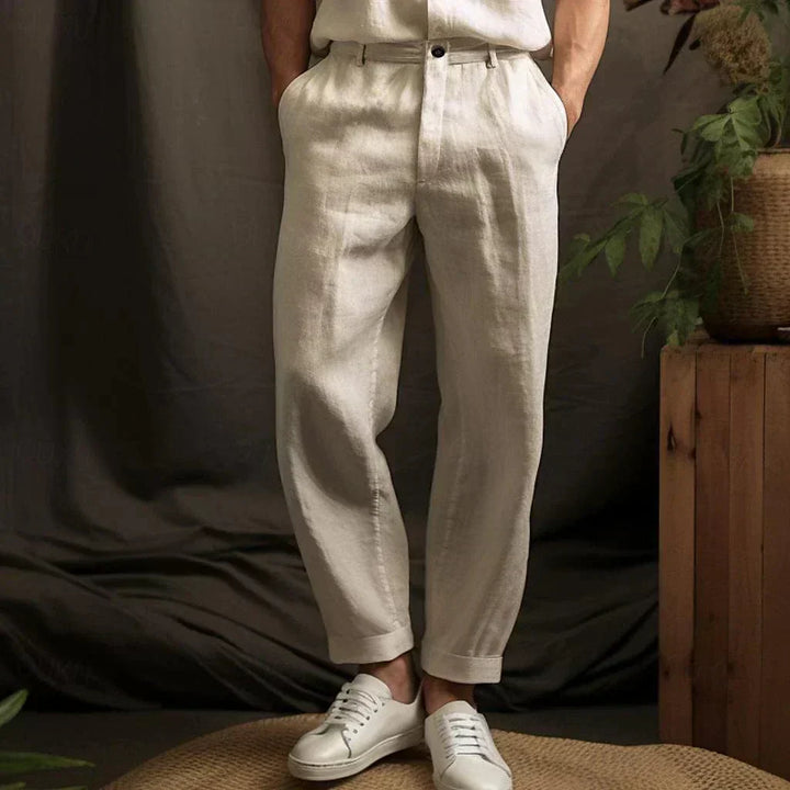 Herren Leinenhose in Beige, elegant und lässig, kombiniert mit weißen Sneakern. Perfekt für Sommermode und stilvolle Freizeitoutfits.
