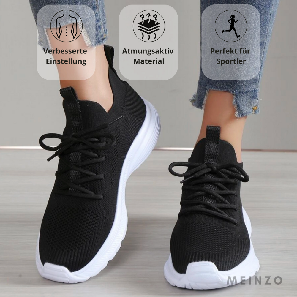 Schwarze Sportschuhe mit weißer Sohle, atmungsaktivem Material, ideal für Sportler. Perfekte Passform, verbessert die Leistung.